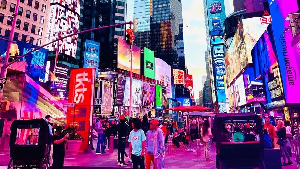 Times Square in New York City, tall skyscrapers, colorful billboards